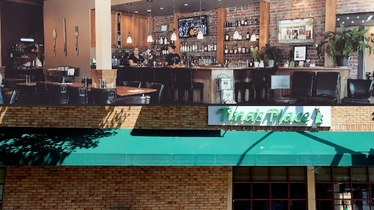 Warm interior with casual seating and brick accents.